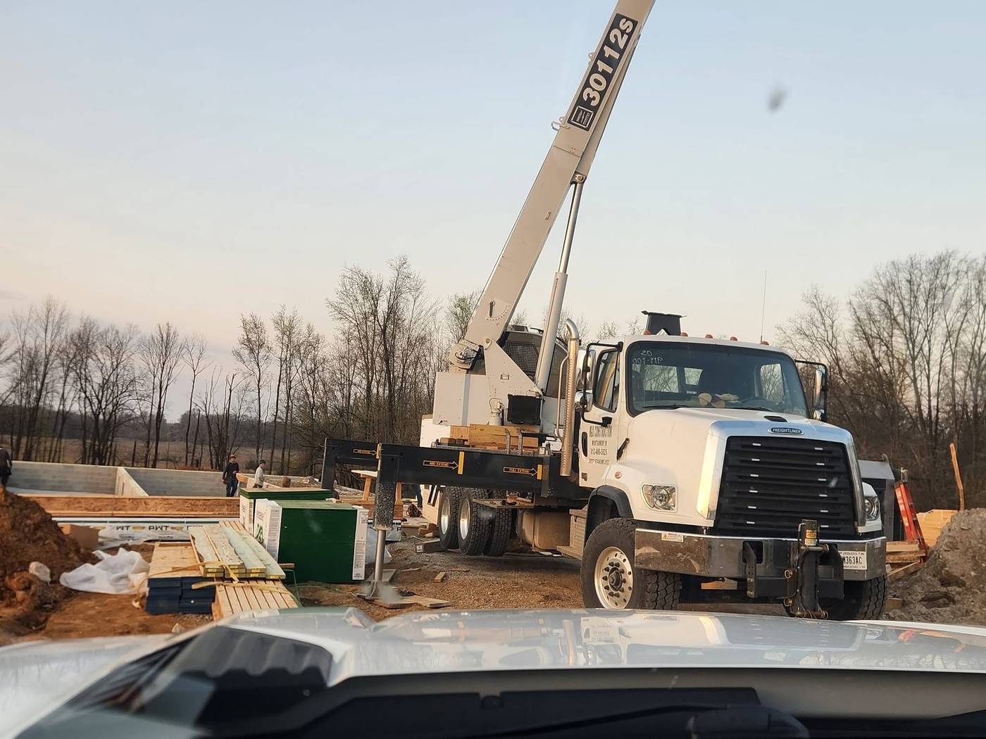 Building materials delivered to a custom home framing site