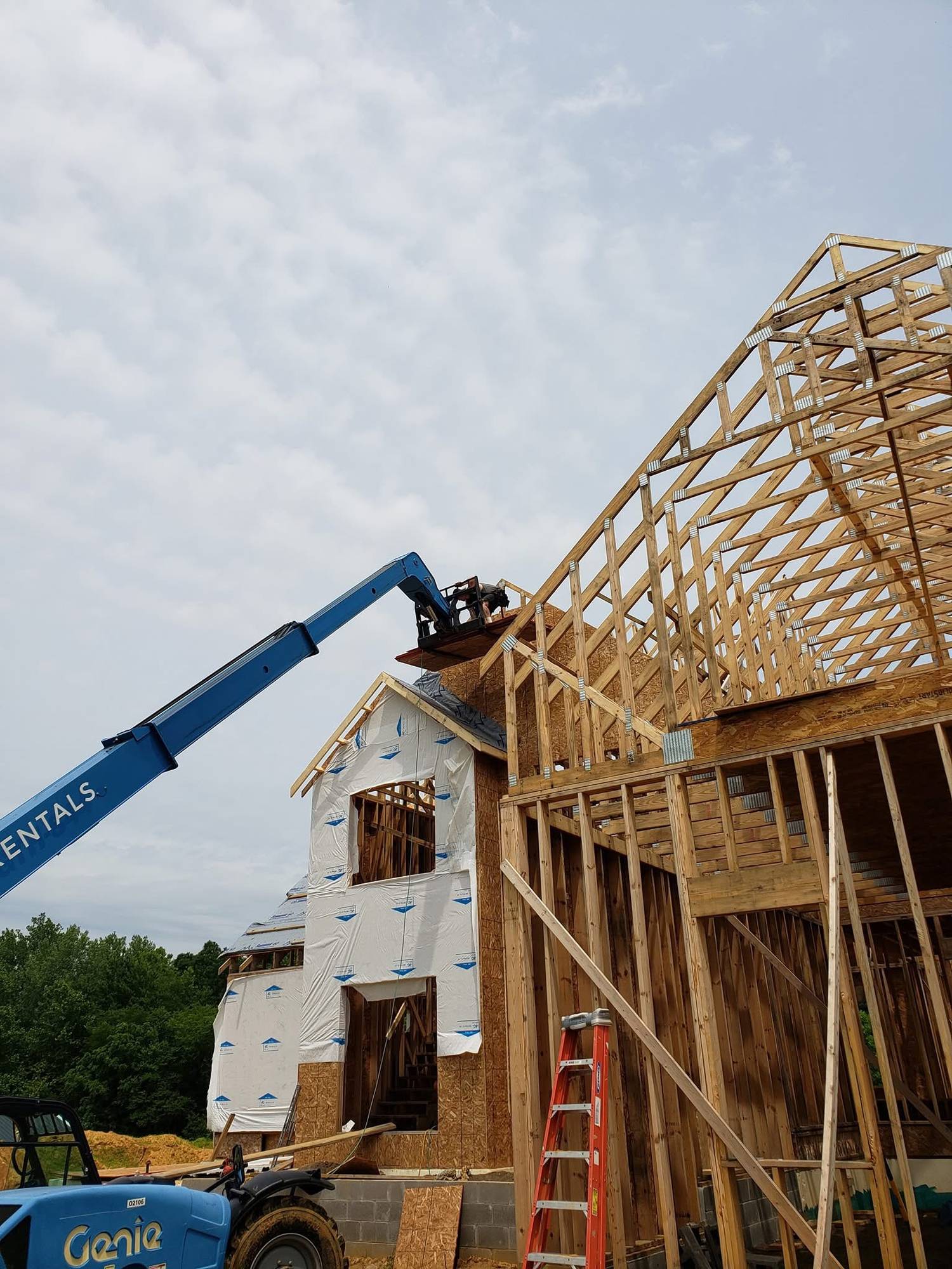 Roof trusses being set on a custom home under construction by Hurt & Sons Construction